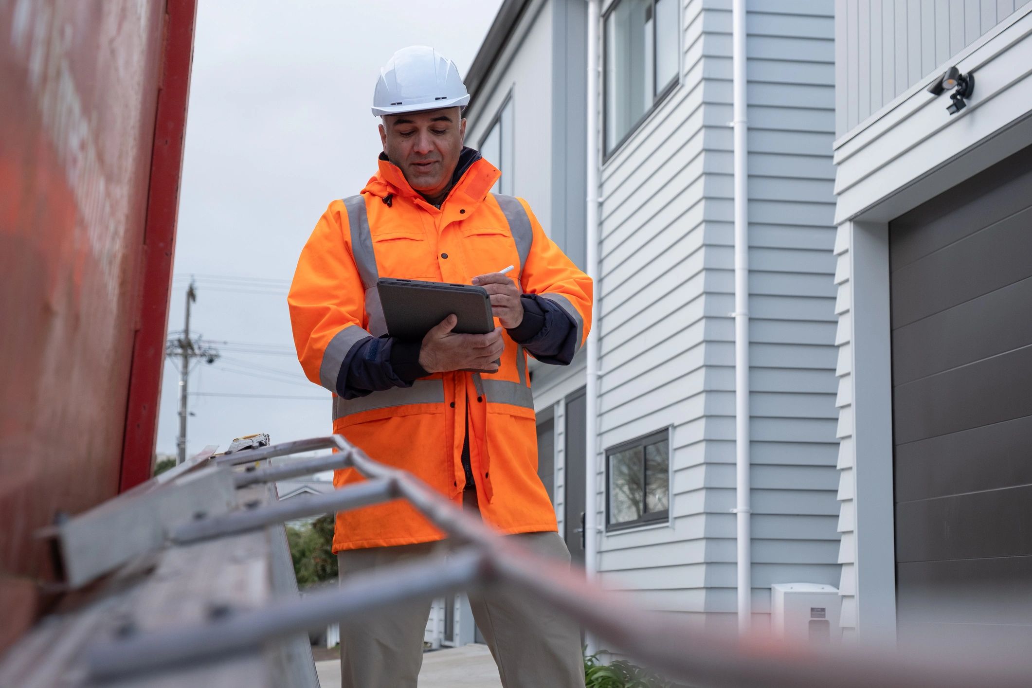 Building inspector reviewing a report on site